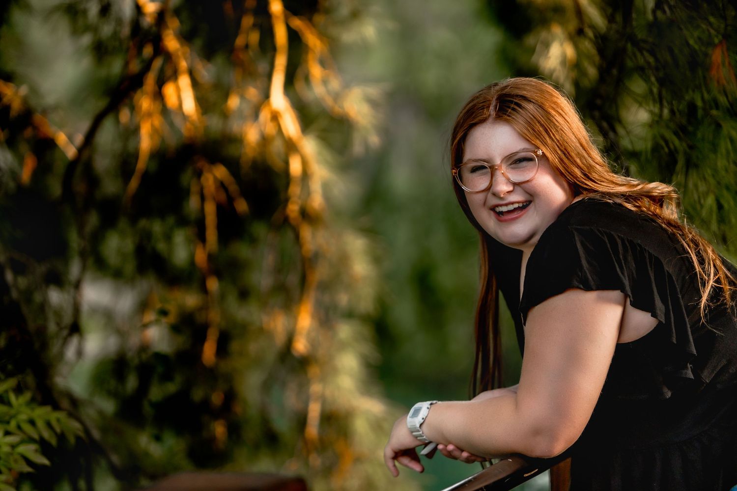 high school senior girl leaning against fence Japanese Stroll Garden