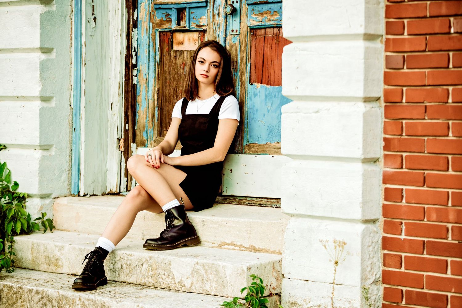 high school senior girl sitting in front of doorway Commercial Street
