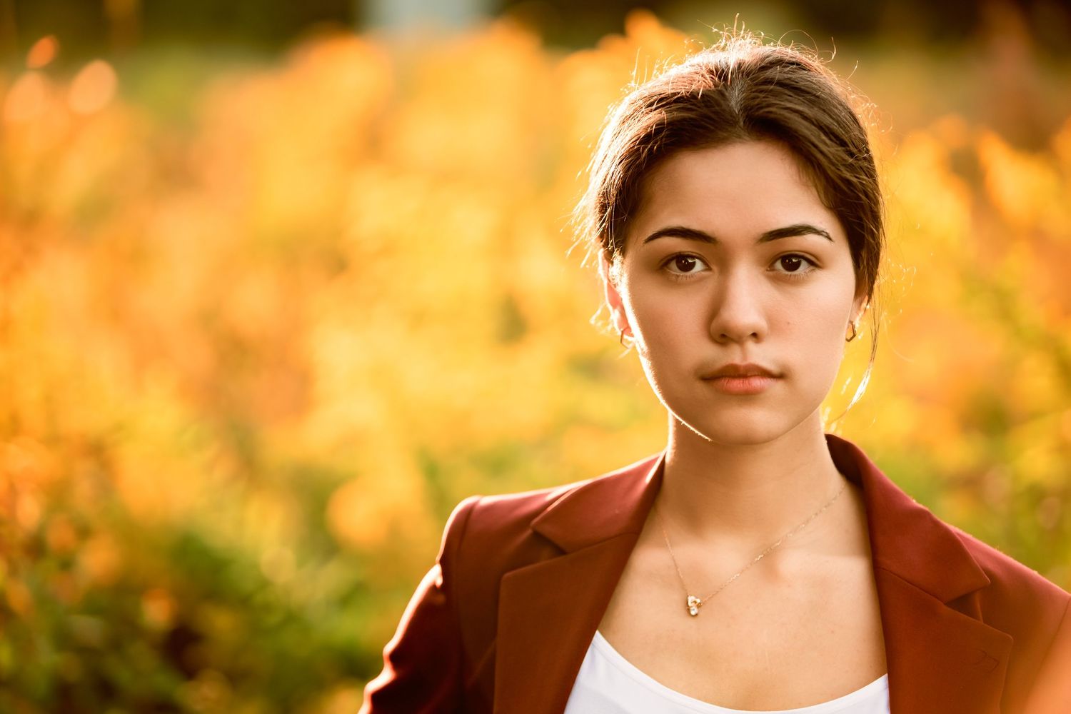 High School Senior girl in front of wild yellow flowers