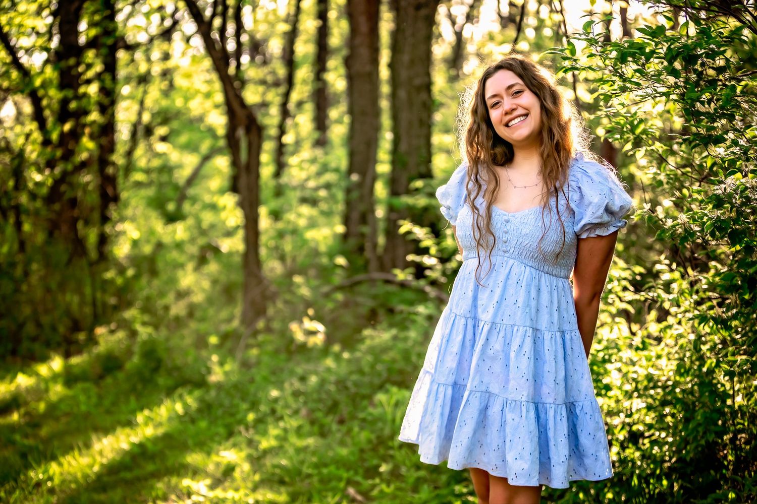 Sun setting through trees high school girl portrait