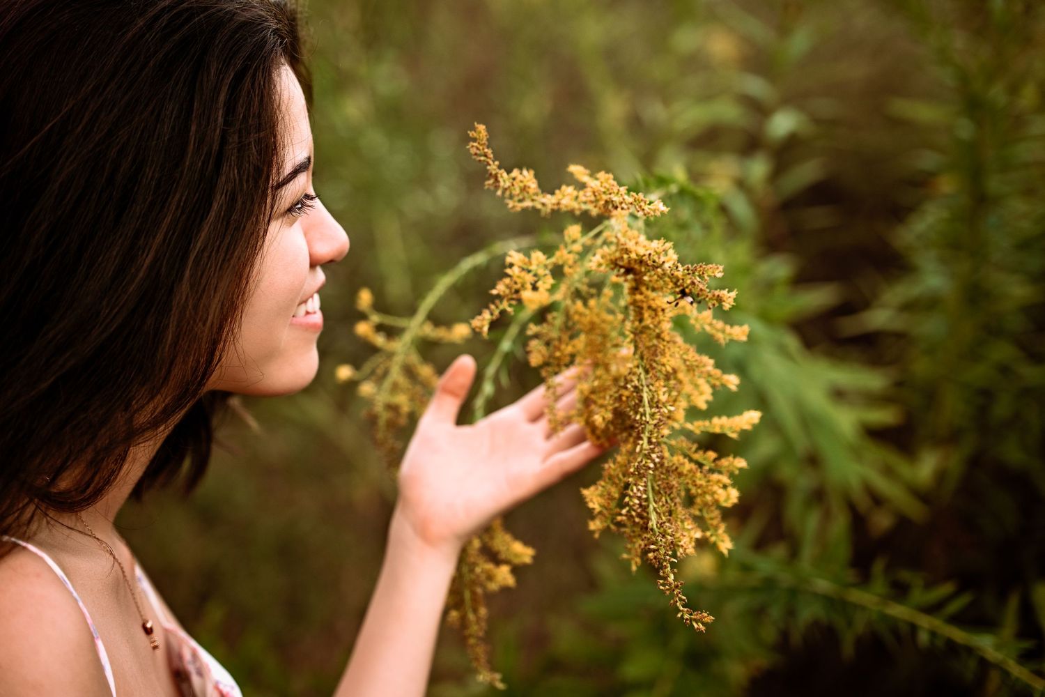 High School Senior girl smelling flowers