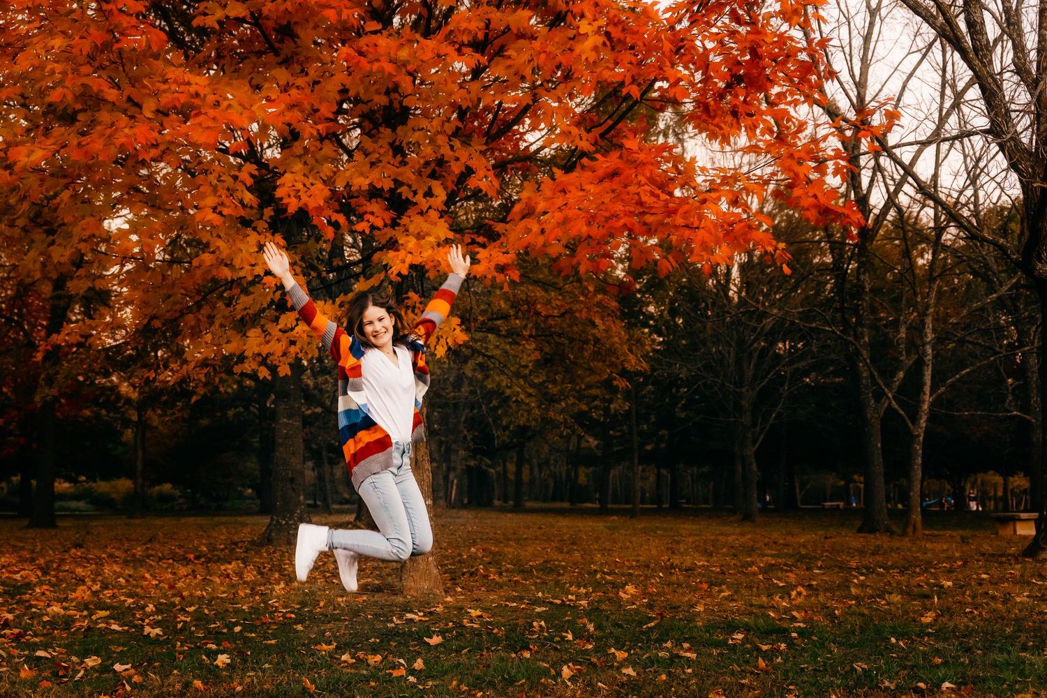 Senior girl portrait jumping in air