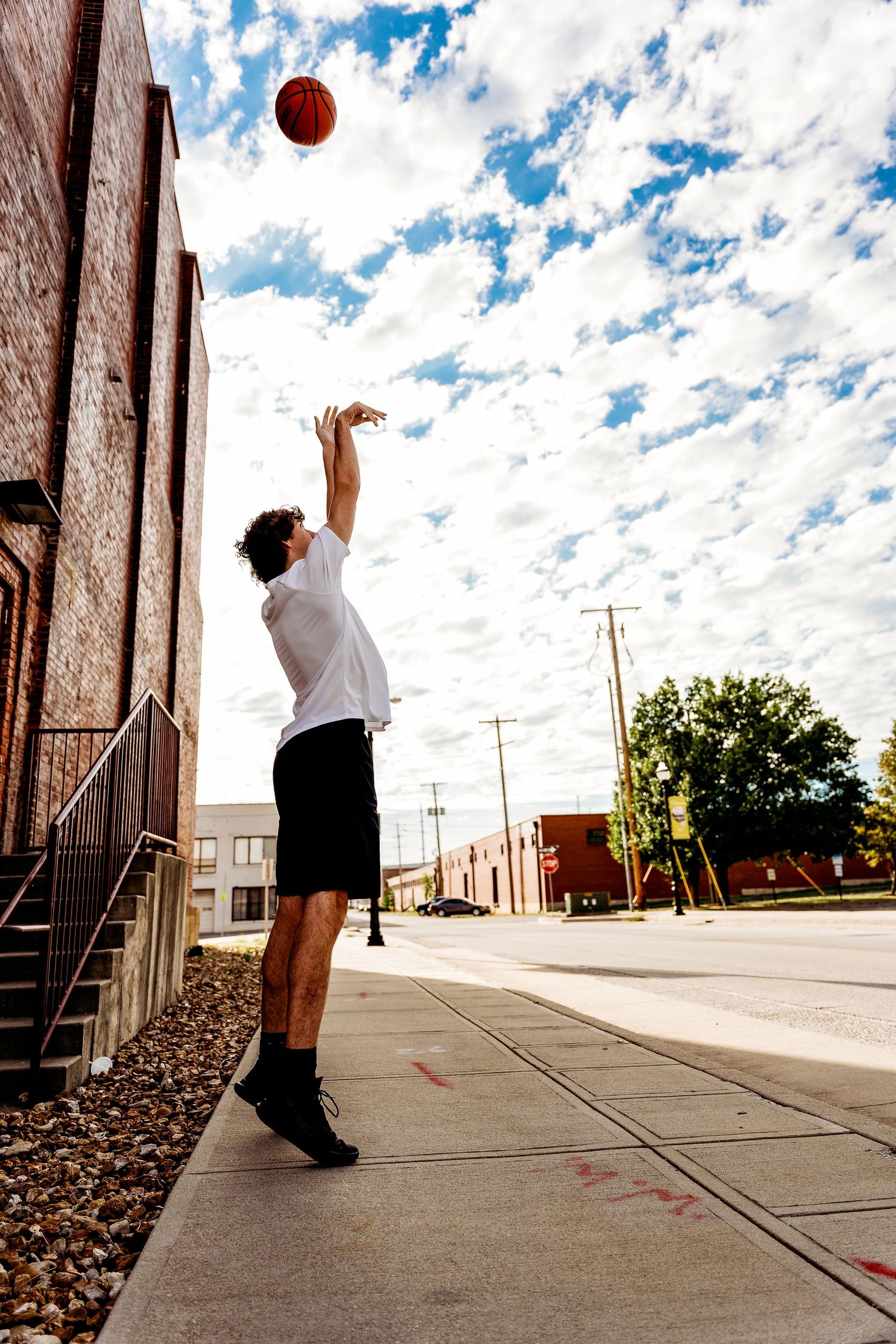 senior boy portrait of shooting basketball