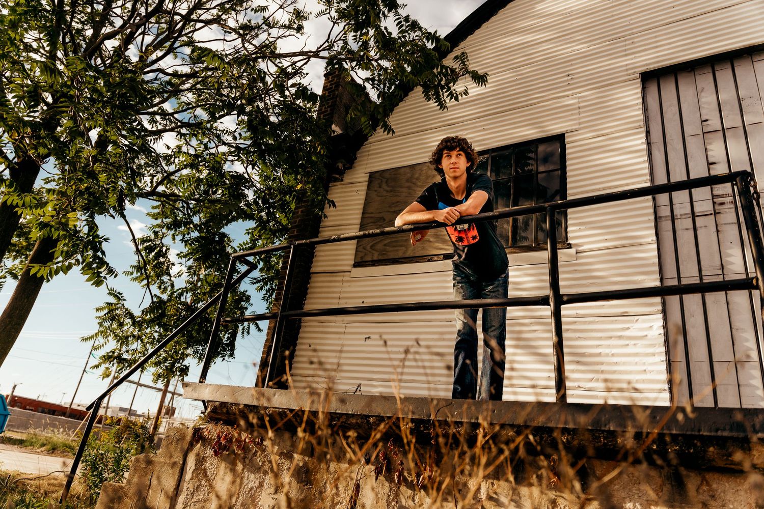 high school senior boy in front of old building