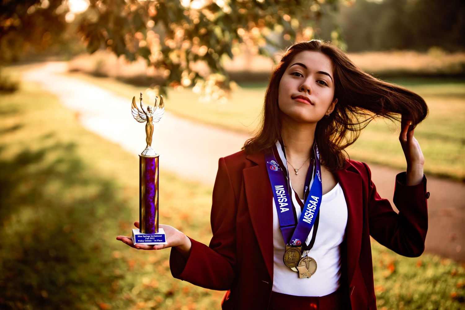 high school senior girl holding trophy