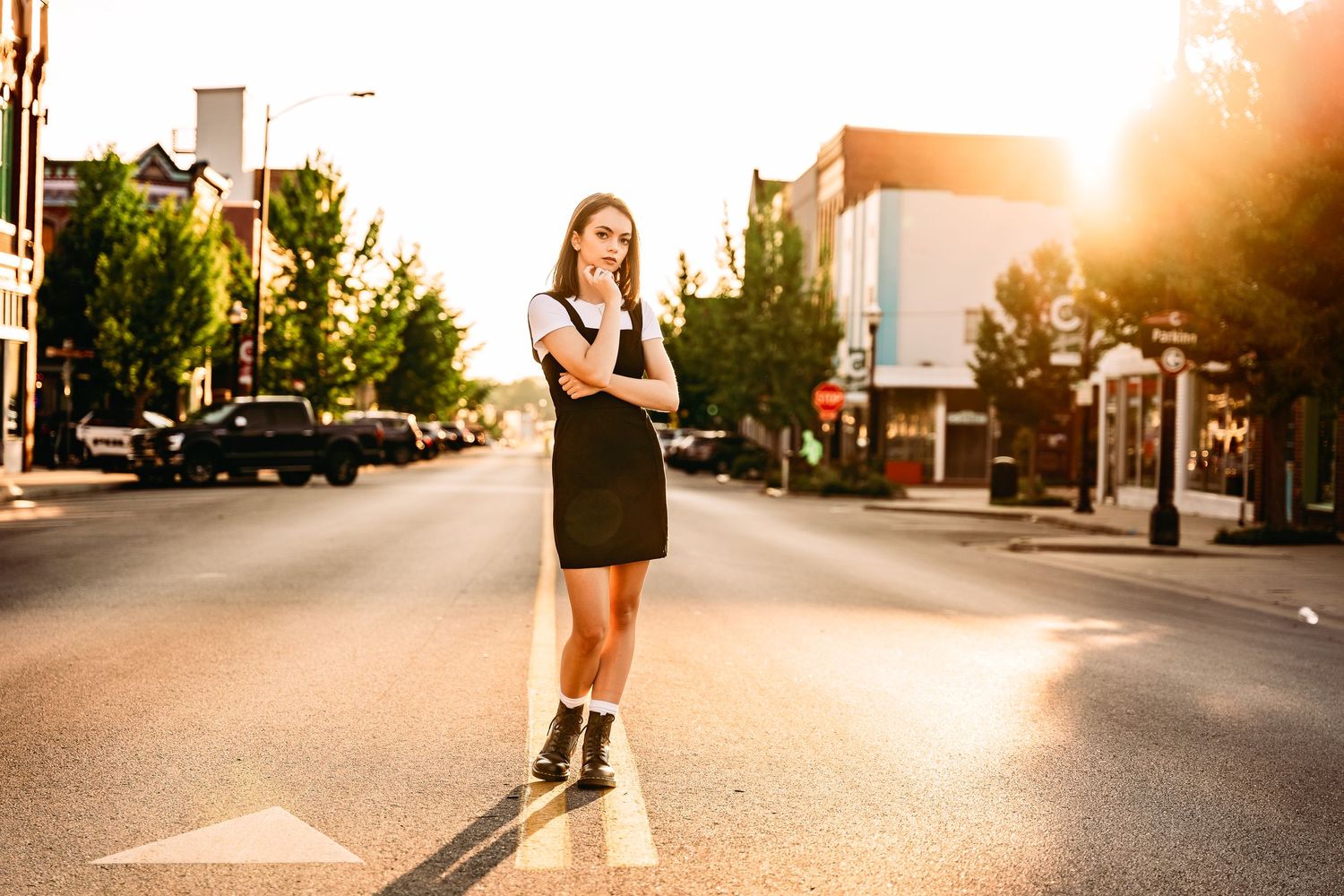 Senior girl standing in the middle of Commercial Street at sunset
