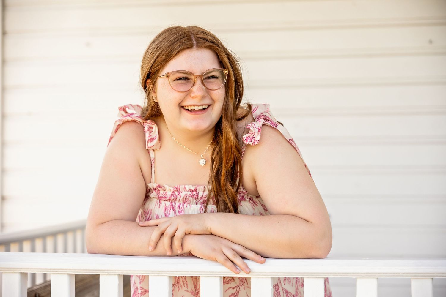 High School Senior Girl leaning on banister of old school building