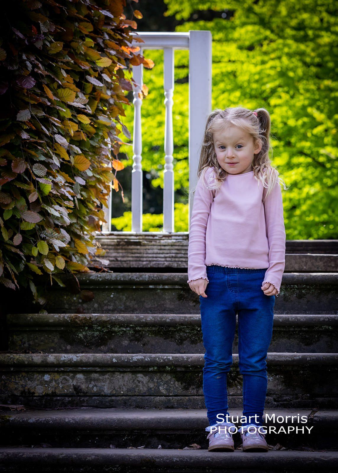 young girl looks sheepish during her portrait session at Walton hall gardens. Stuart Morris Photography