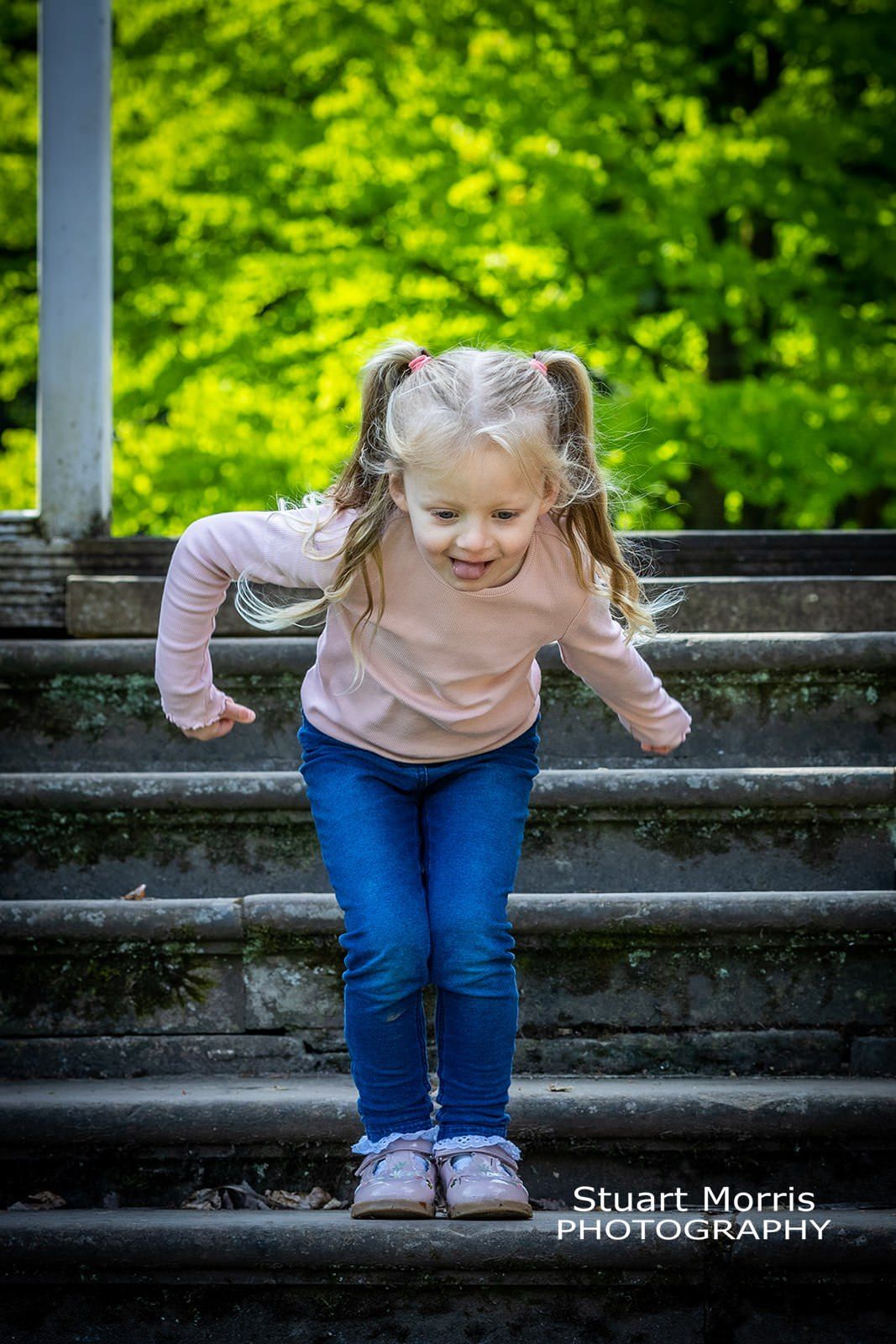 young girl gets ready to jump during her mini outdoor portrait session by Stuart Morris Photography.