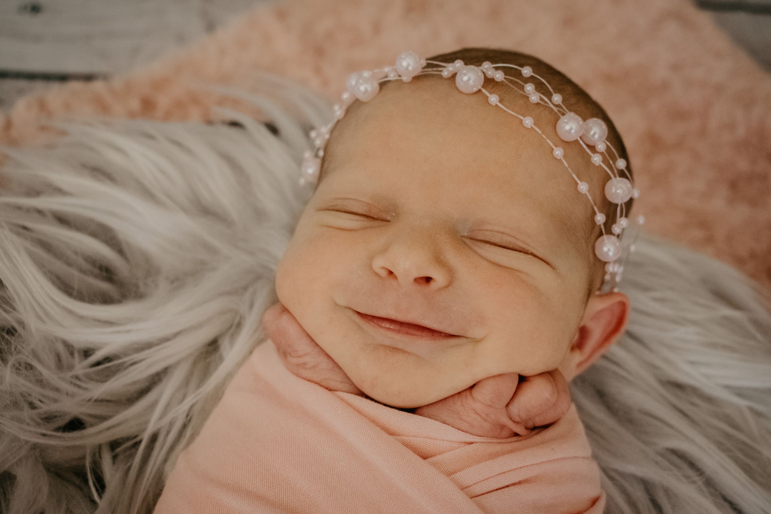 baby girl smiling during newborn photos
