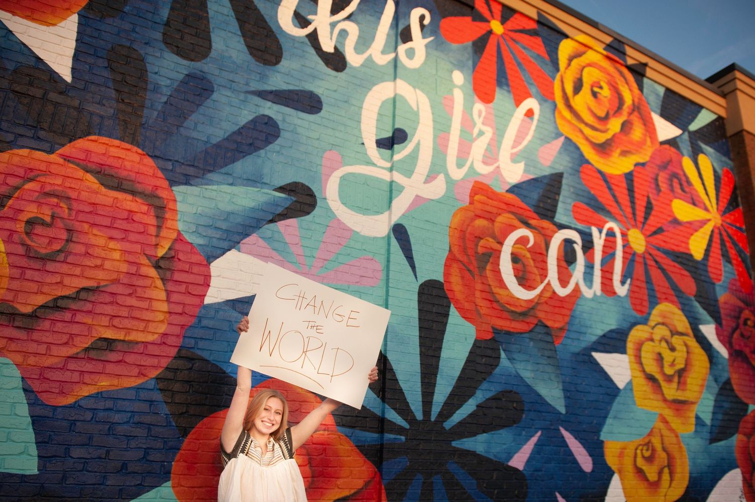 Colorful mural wall featuring bright floral designs and text art.