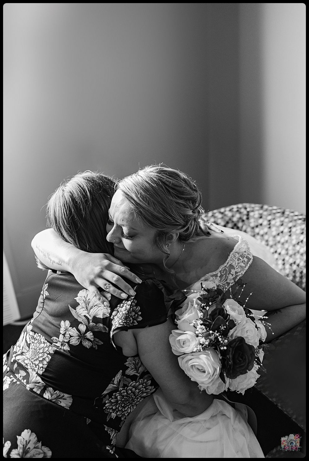 An emotional black and white moment between bride and loved one.