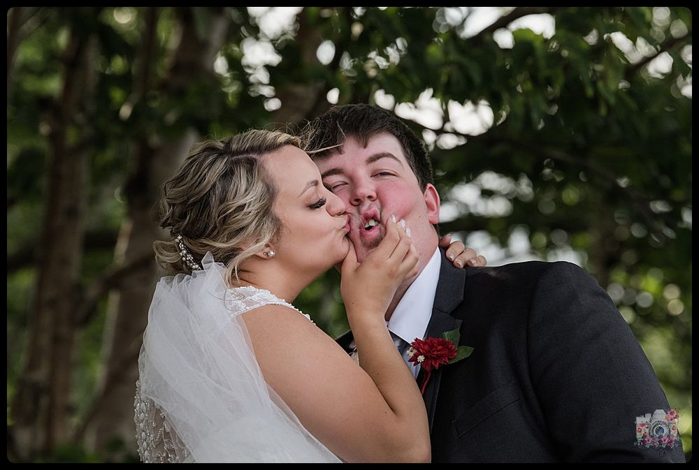 Playful wedding portrait showing a candid moment of joy and laughter outdoors.