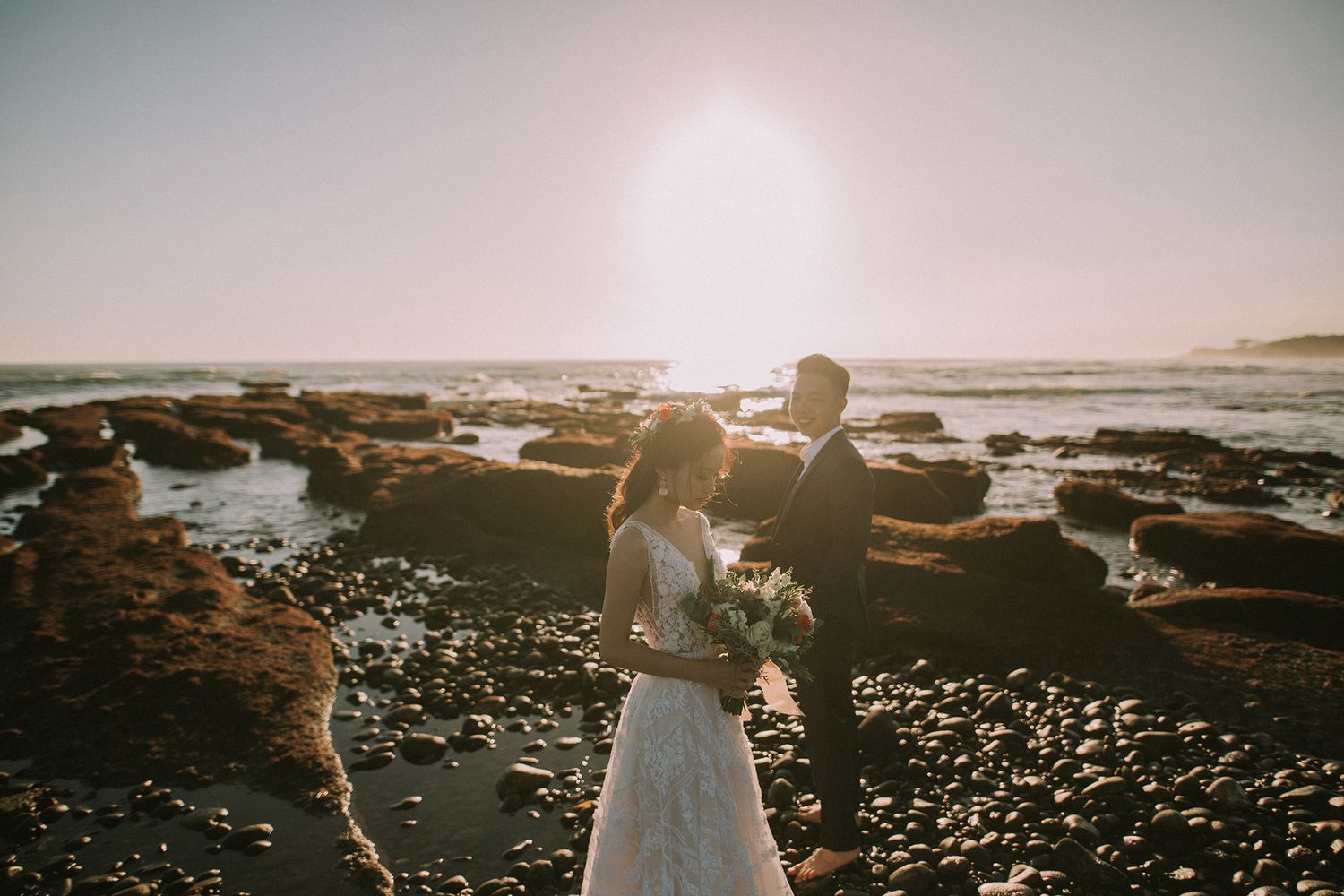 Sunset beach wedding photography with dramatic coastal landscape.