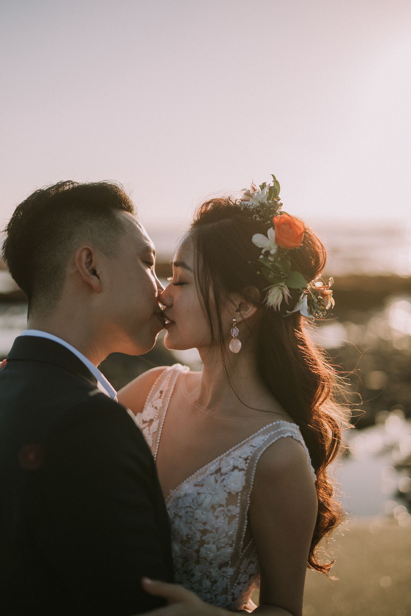 Romantic sunset wedding portraits with soft golden light and delicate lace details.