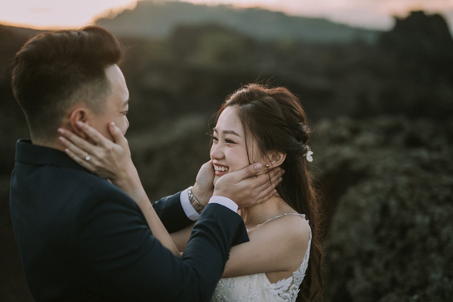 Intimate wedding moment captured against rugged mountain backdrop.
