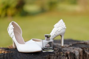 Wedding outside detail photograph of shoes and perfume