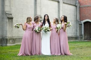 Bride and bridesmaid holding bouquets of flowers