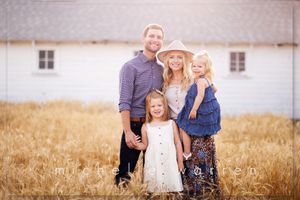 Family portrait series in golden wheat field during sunset.