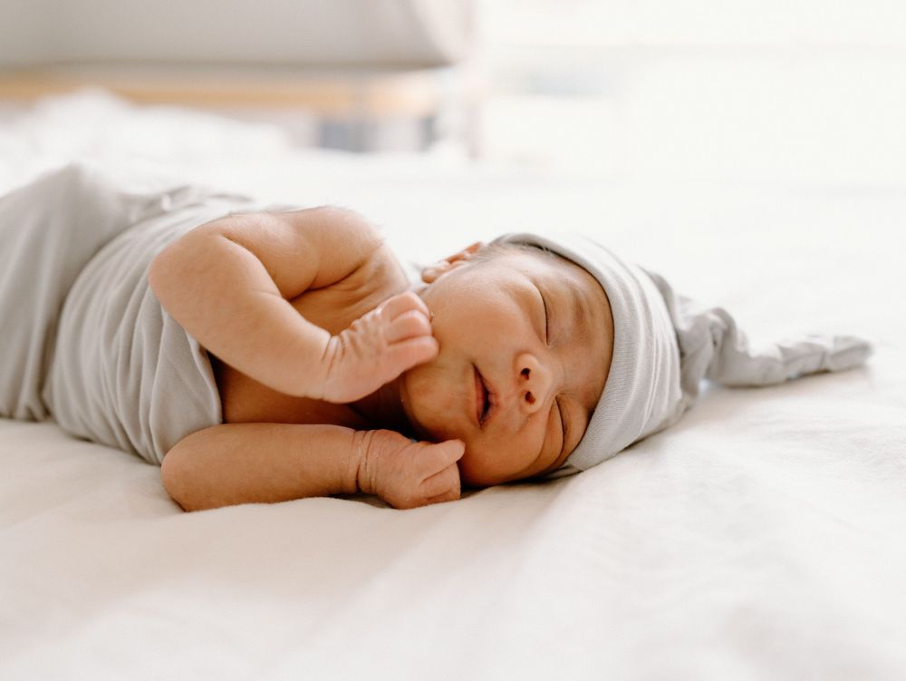 A family photoshoot by Moments With Kell on Oahu in Hawaii with new baby sleeping