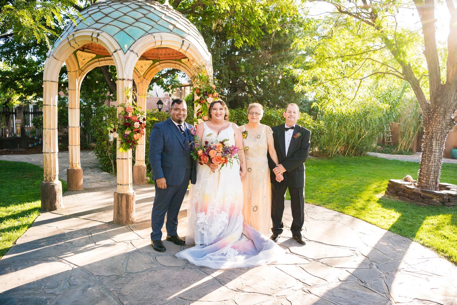 A Bride and Groom with the Brides Parents after their wedding ceremony.