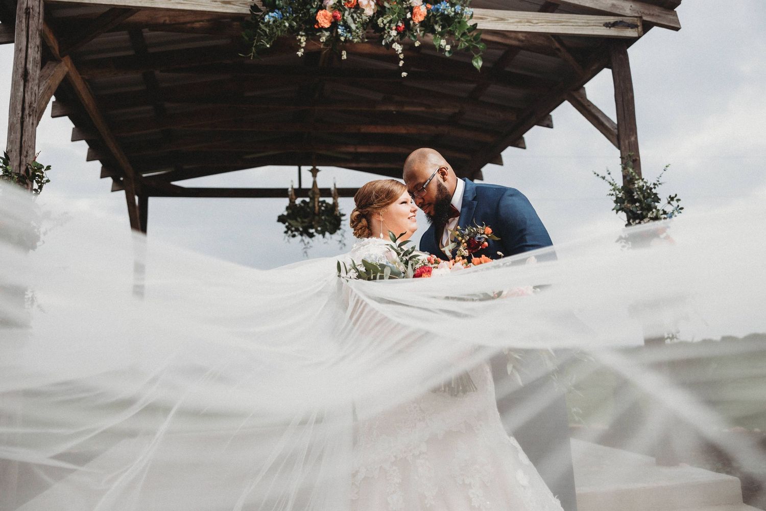 Groom holding his bride and posing on their wedding day at The Barn at Wolf Ridge Farm