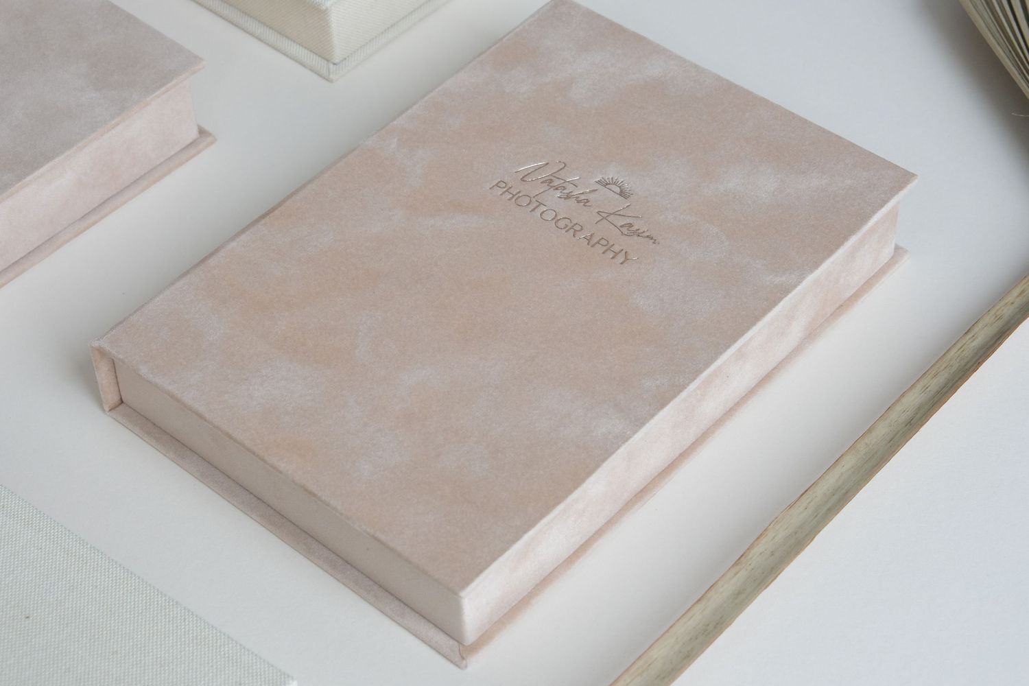 Collection of blush pink wedding albums arranged in elegant flat lay composition.