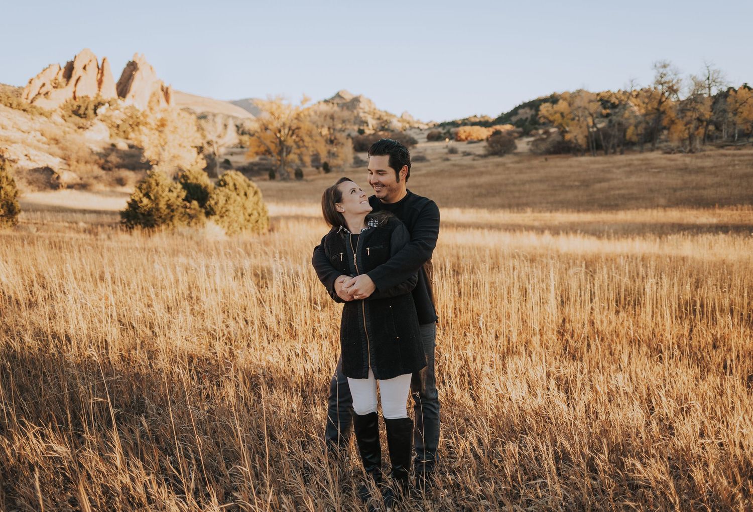 a couple embracing at sunrise in Garden of the Gods park