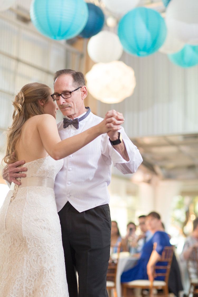 Newlyweds sharing their first dance under balloons