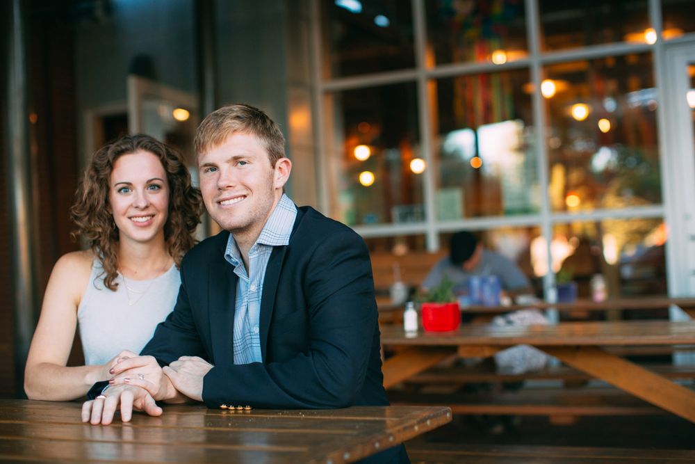 A couple shares intimate moments together at a restaurant, shown in a series of candid evening shots.