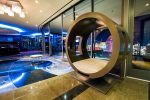 Modern lobby with circular portal feature and blue LED lighting accents.