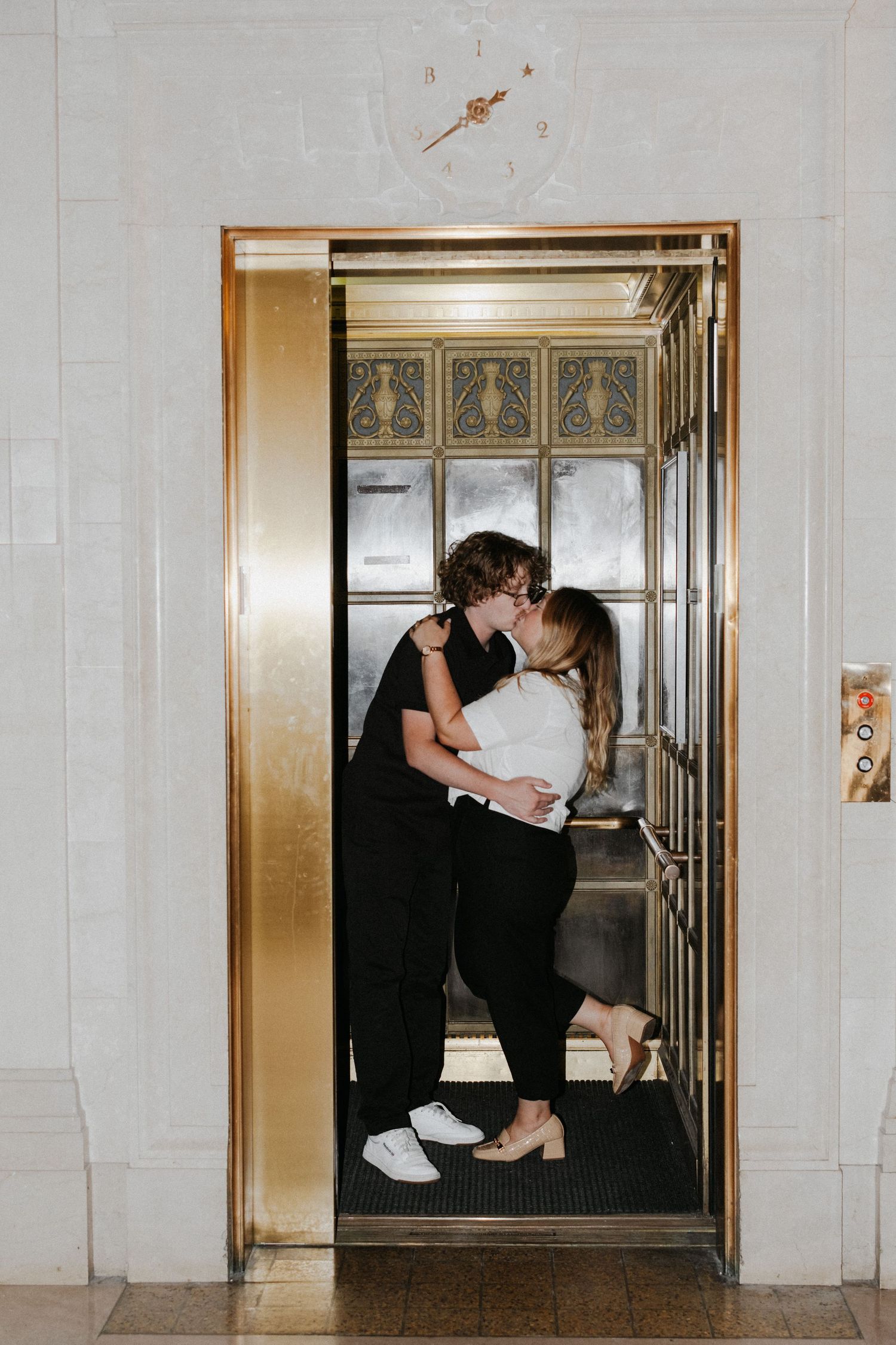 Artistic wedding photos taken in an elevator with industrial design elements.