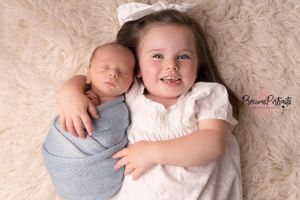 sibling posing in a safe and cuddly manner
