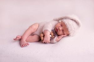 simple posed on baby's hand styled with teddy in a sleepy pose