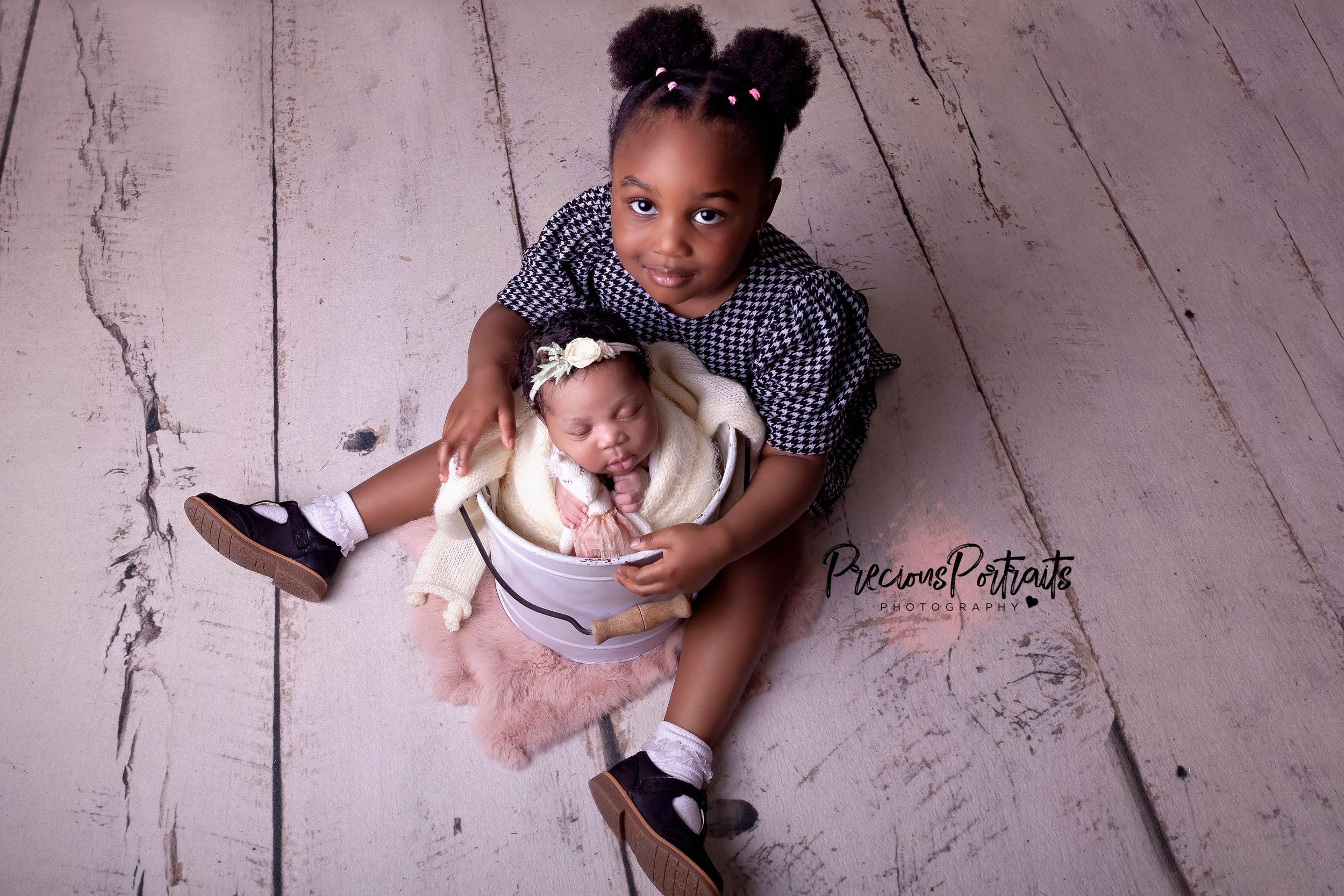 sibling love, carefully wrapped and posed in a prop so big sister can safely hold