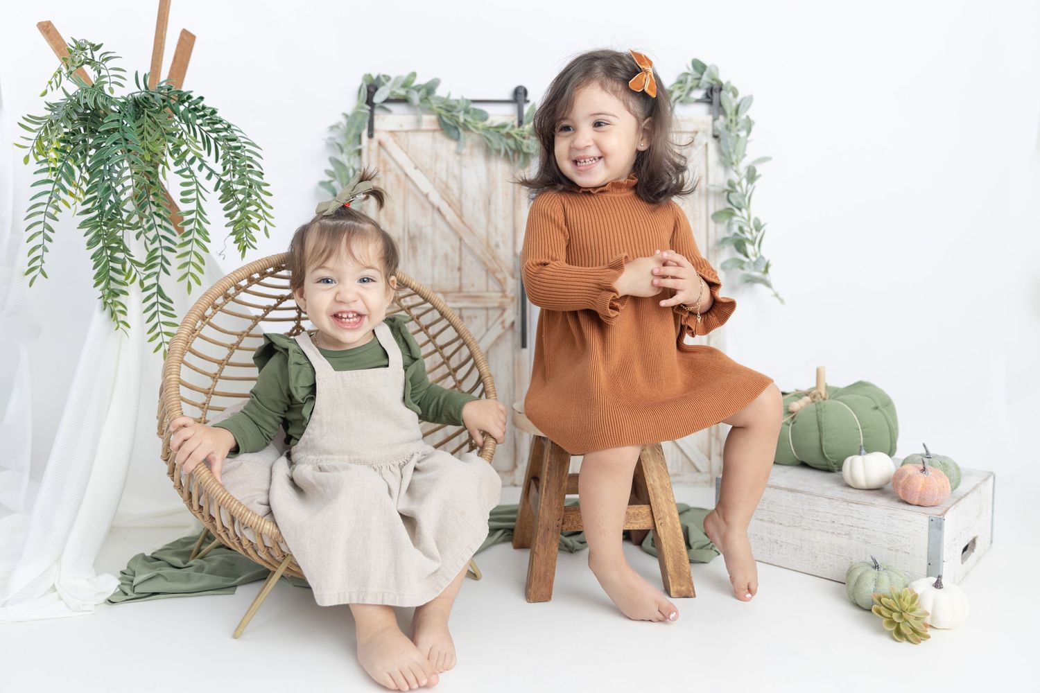 Rustic studio setup with rattan chair, wooden doors and autumn decorations.