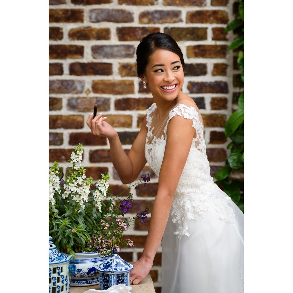 Bride's finishing makeup touches on her wedding day in Akron, Ohio.