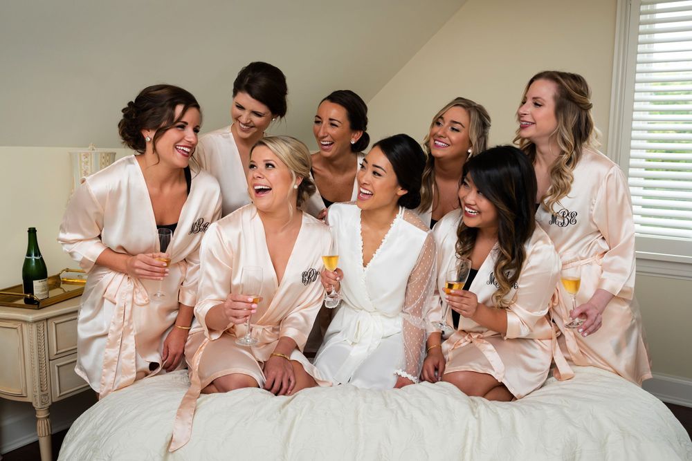 Bridesmaids laughing on wedding day in Akron, Ohio.