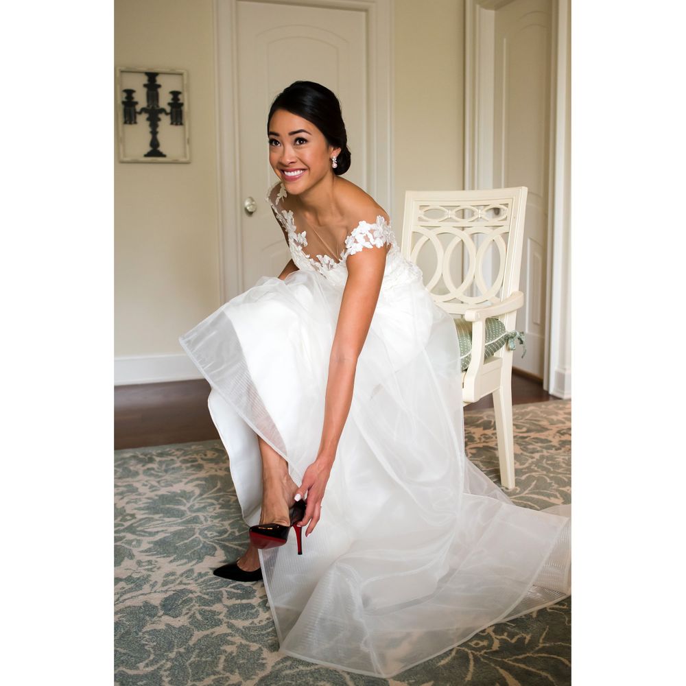 Bride adjusts shoes on wedding day in Akron, Ohio.