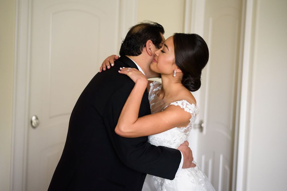 Father and bride hug before wedding ceremony in Akron, Ohio.