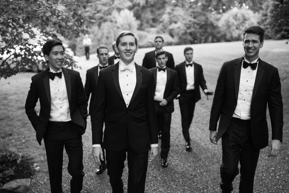 Groom and groomsmen walking on wedding day in Akron, Ohio.