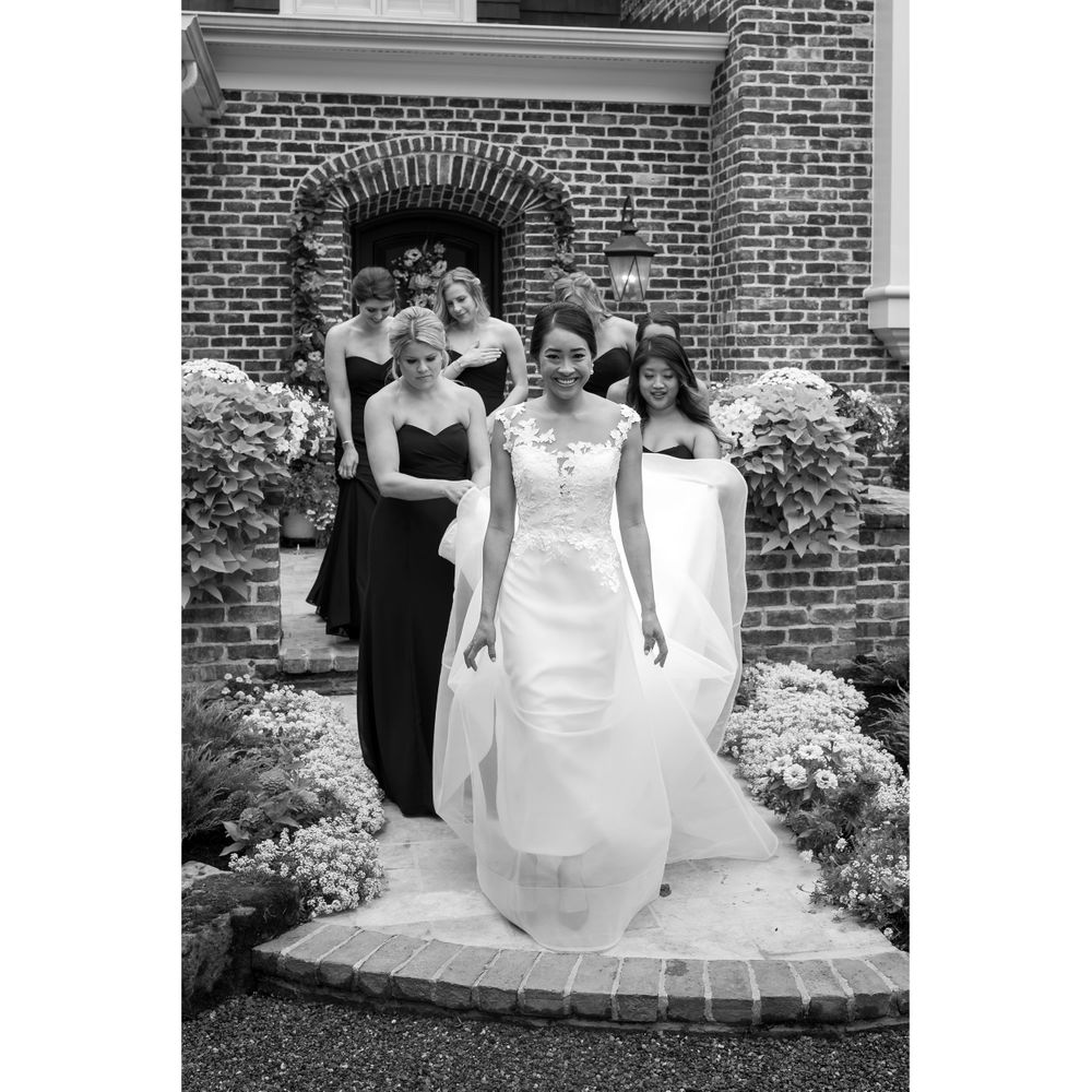 Bride and bridesmaids walking on wedding day in Akron, Ohio.
