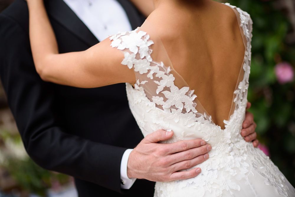 Bride and groom embrace on wedding day in Akron, Ohio.