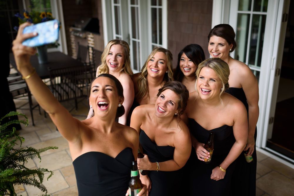 Bridesmaids talk selfie on wedding day in Akron, Ohio.