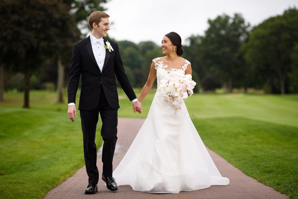 Bride and groom walking on their wedding day at Fairlawn Country Club in Akron, Ohio.