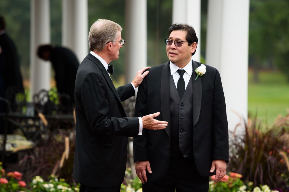 Fathers interact on wedding day at Fairlawn Country Club in Akron, Ohio.