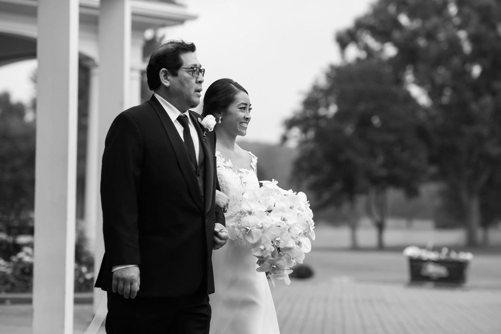 Father prepares to walk daughter down aisle on her wedding day at Fairlawn Country Club in Akron, Ohio.