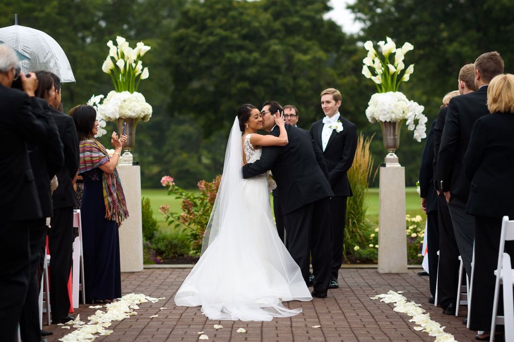 Bride and father his during wedding ceremony at Fairlawn Country Club in Akron, Ohio.