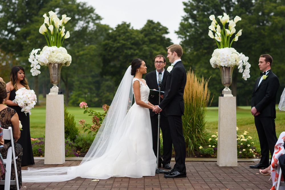 Bride and groom exchange vows during wedding ceremony at Fairlawn Country Club in Akron, Ohio.