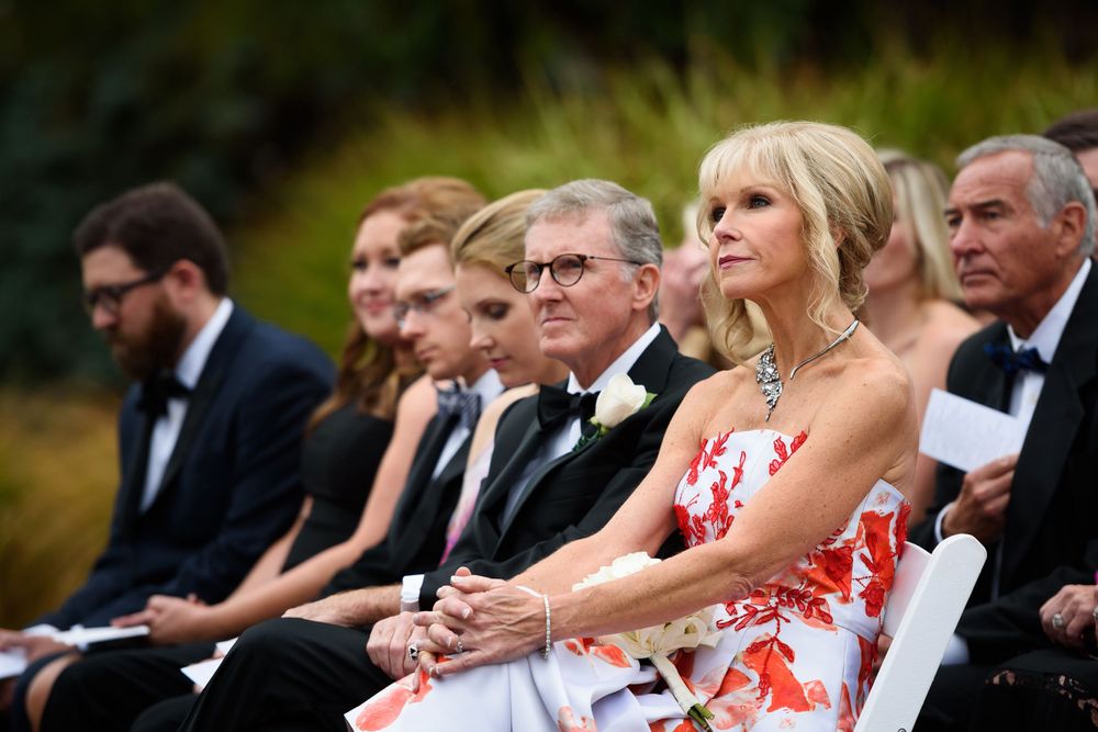 Groom's parents watch outdoor wedding ceremony at Fairlawn Country Club in Akron, Ohio.